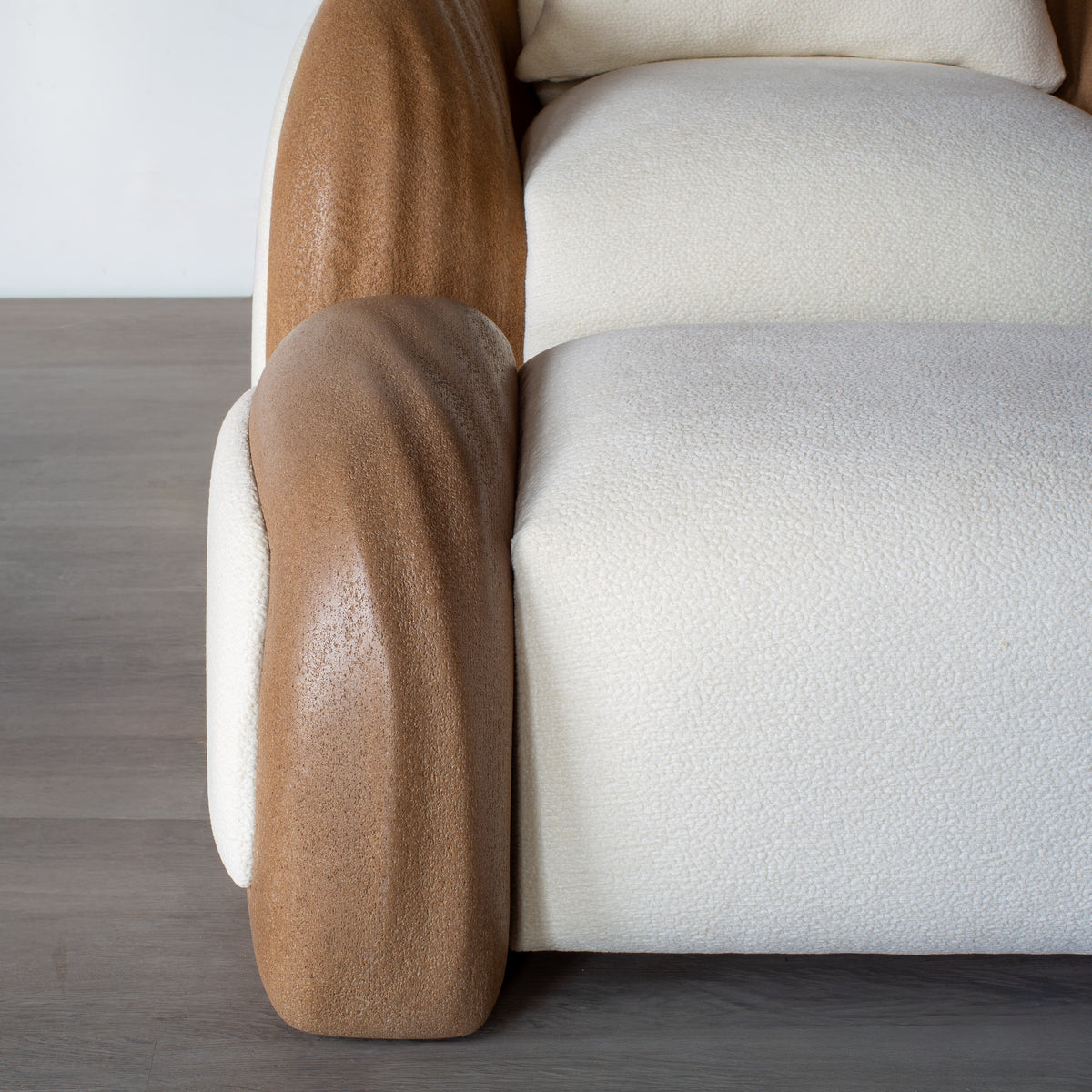 Close-up of the Listening Chair’s textured upholstery beside its curved shell.