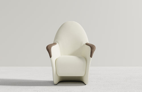 Attune chair viewed from the front, with white upholstery and dark timber handrests against a light studio background